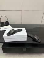Black leather slide sandals shown with textured strap and gold Dior branding