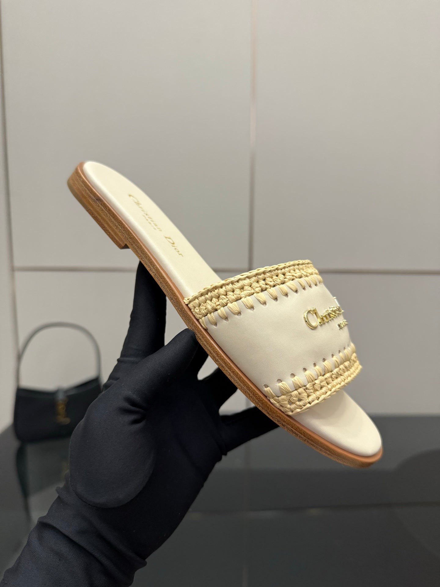 Women's slide sandal on hand, cream footbed with gold logo and woven strap