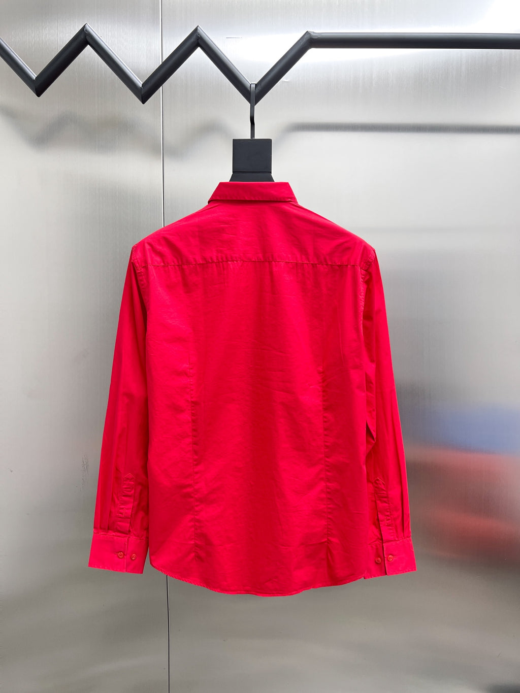 Red long-sleeve button-up shirt, back view