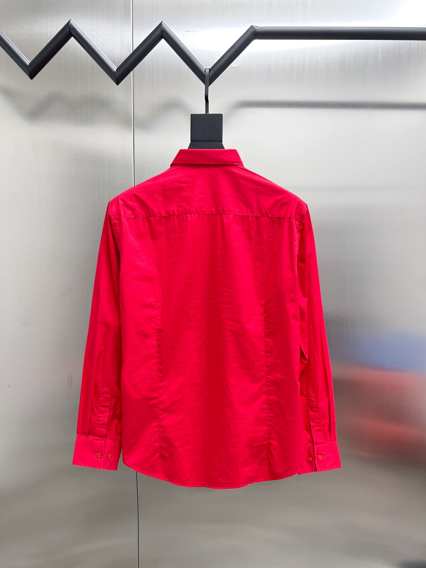 Red long-sleeve button-up shirt, back view