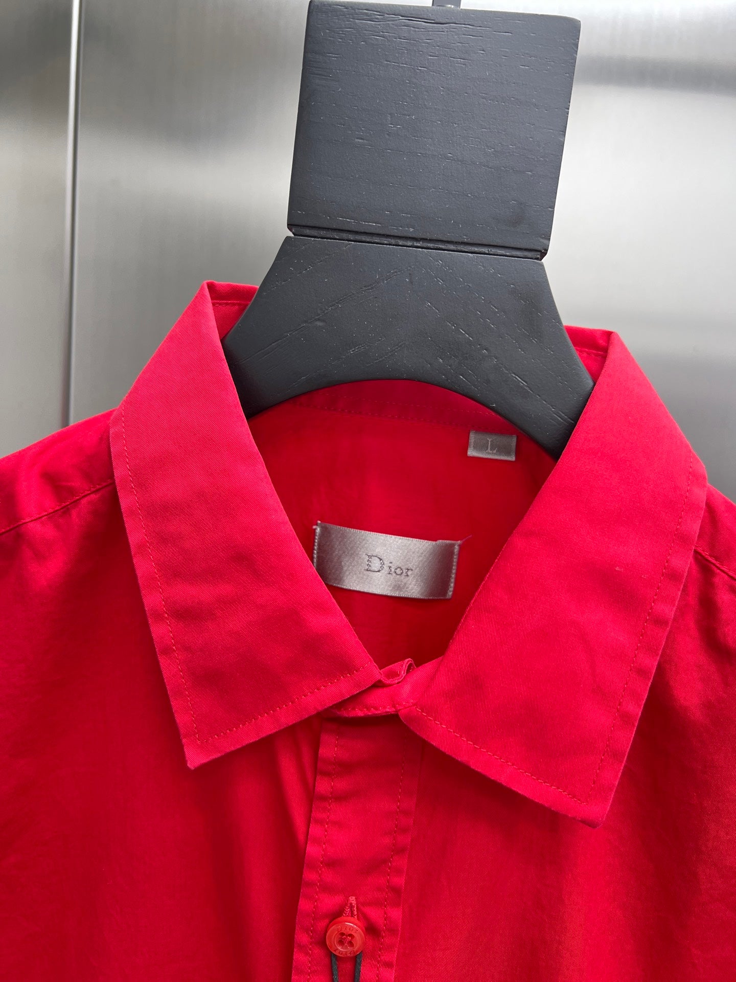 Red long-sleeve button-up shirt collar with interior label