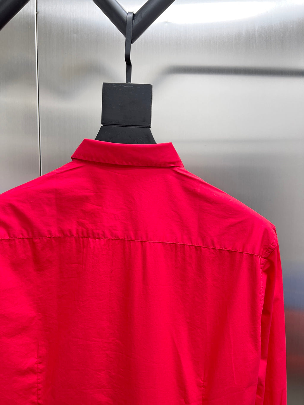 Red long-sleeve shirt on hanger with stand collar and button front