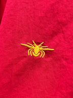 Red shirt with small yellow emblem embroidery