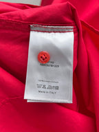 Red clothing label on shirt with care instructions and Made in Italy