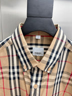 Burberry plaid shirt neckline with tag, pointed collar, and beige front buttons