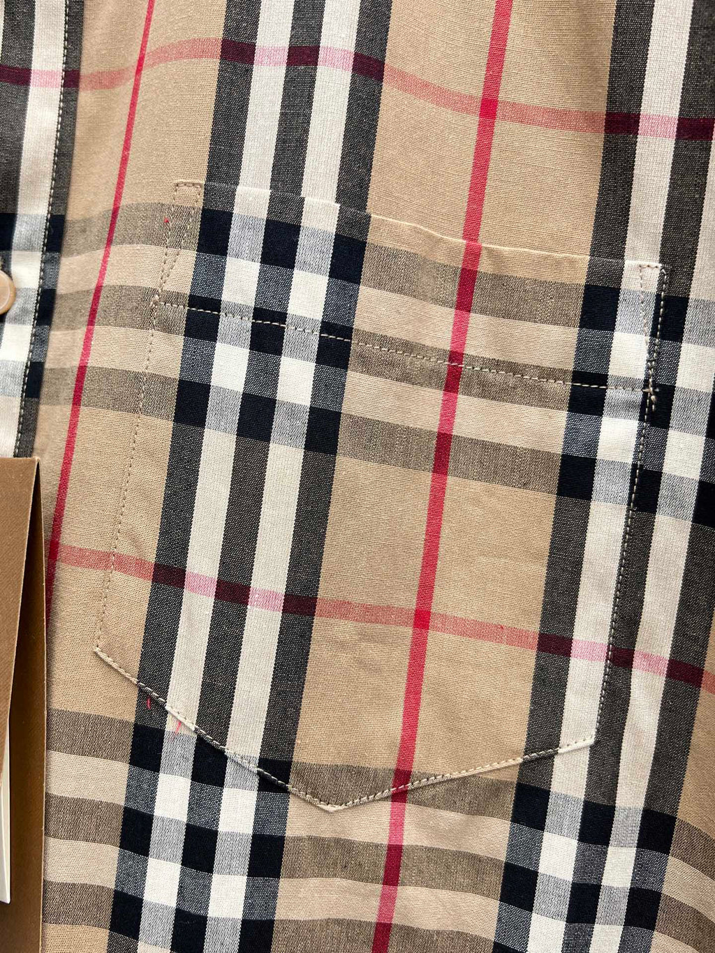 Burberry plaid shirt chest panel showing stitched seams and beige navy red checks