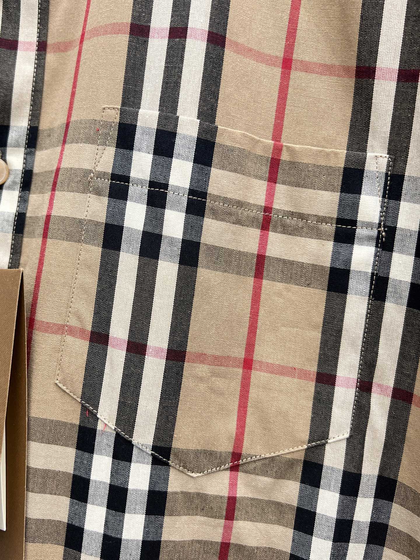 Burberry plaid shirt chest panel showing stitched seams and beige navy red checks