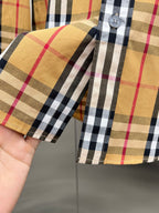 Long-sleeve plaid shirt sleeve cuff with button tab, tan, black, and red checks