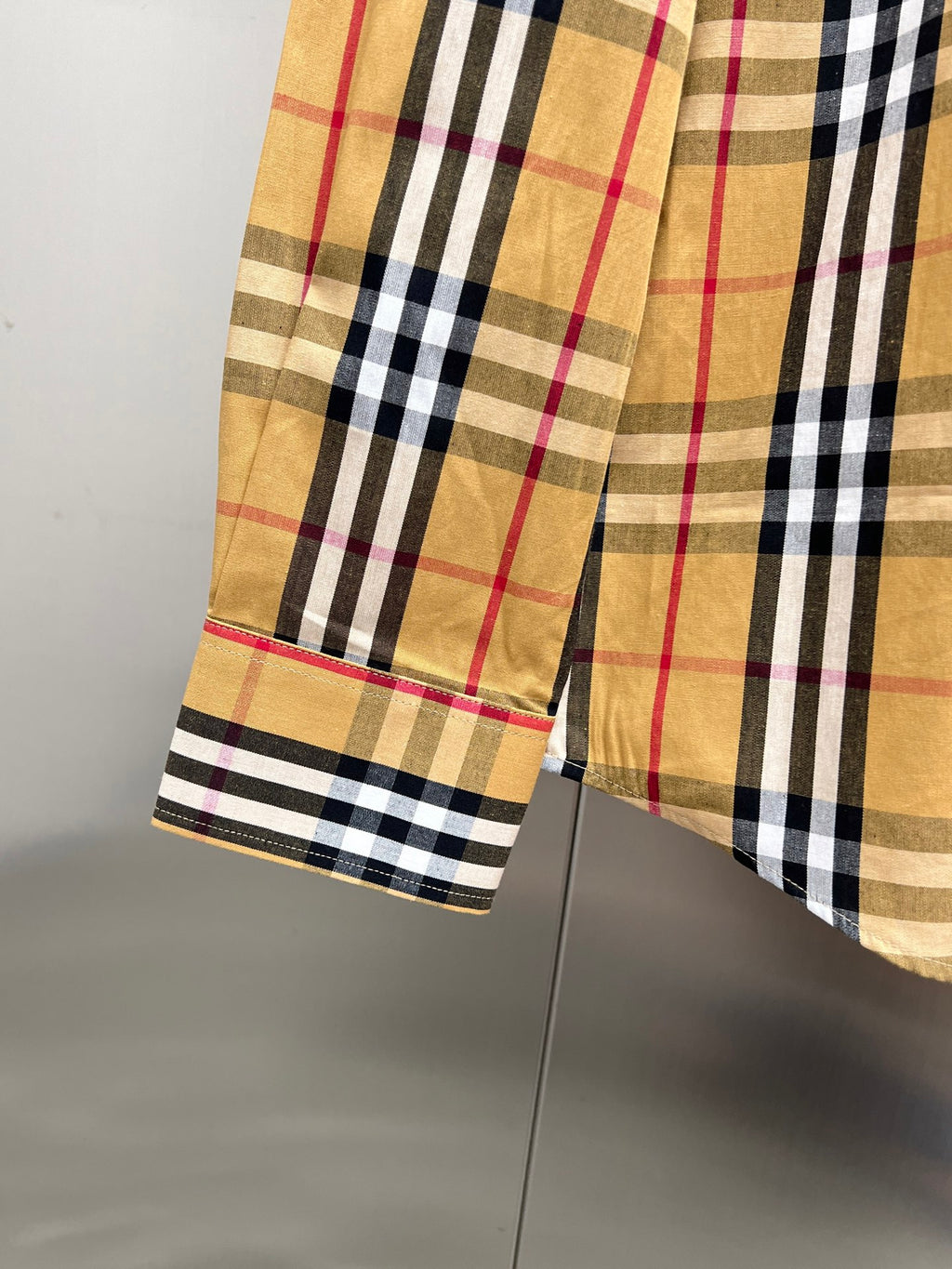 Burberry plaid shirt cuff and hem detail, long sleeves with buttoned cuff