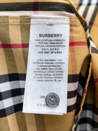 Burberry fabric label on plaid shirt, showing care info and material composition