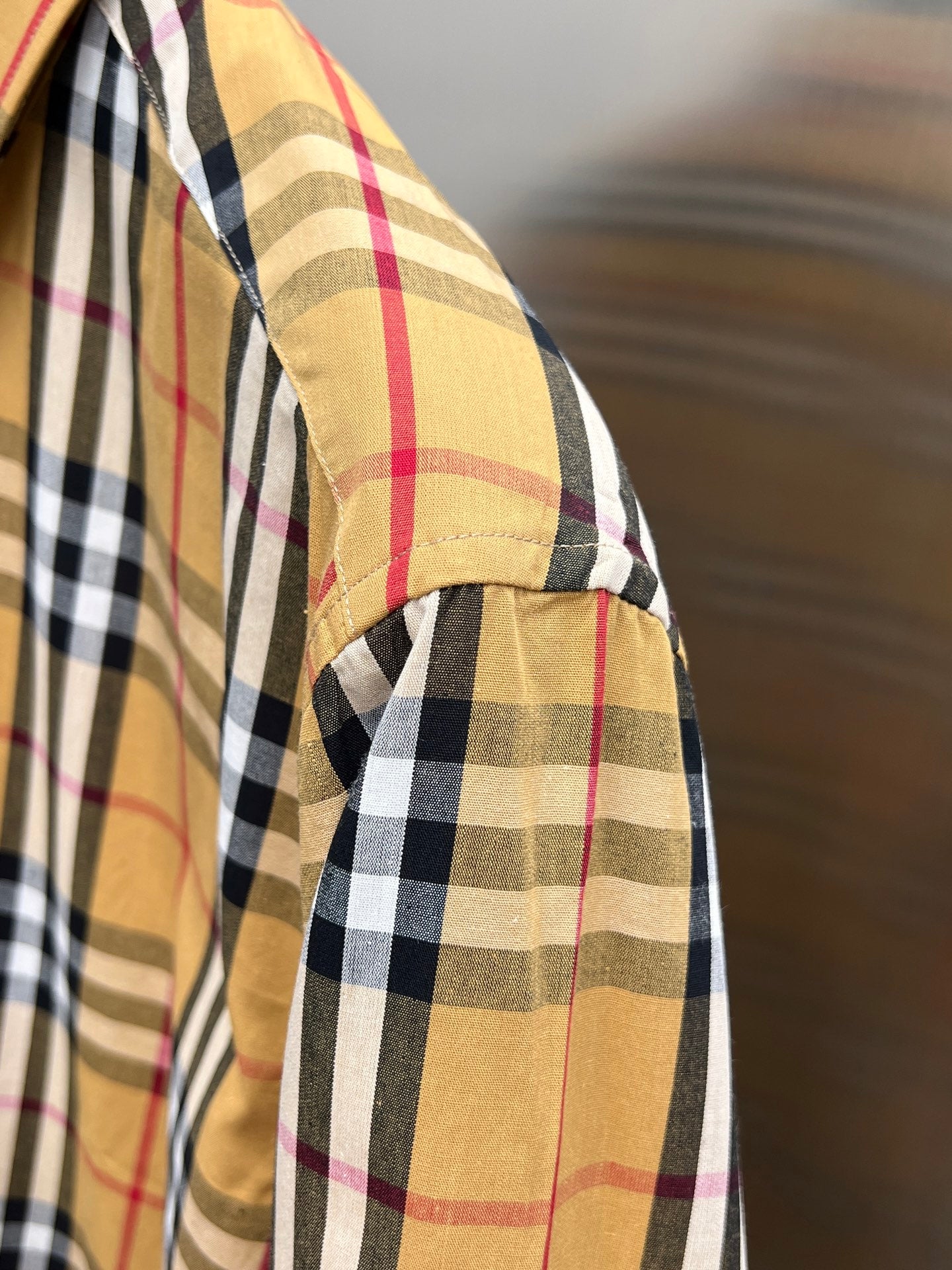 Burberry plaid shirt sleeve close-up with cuff and side seam detail