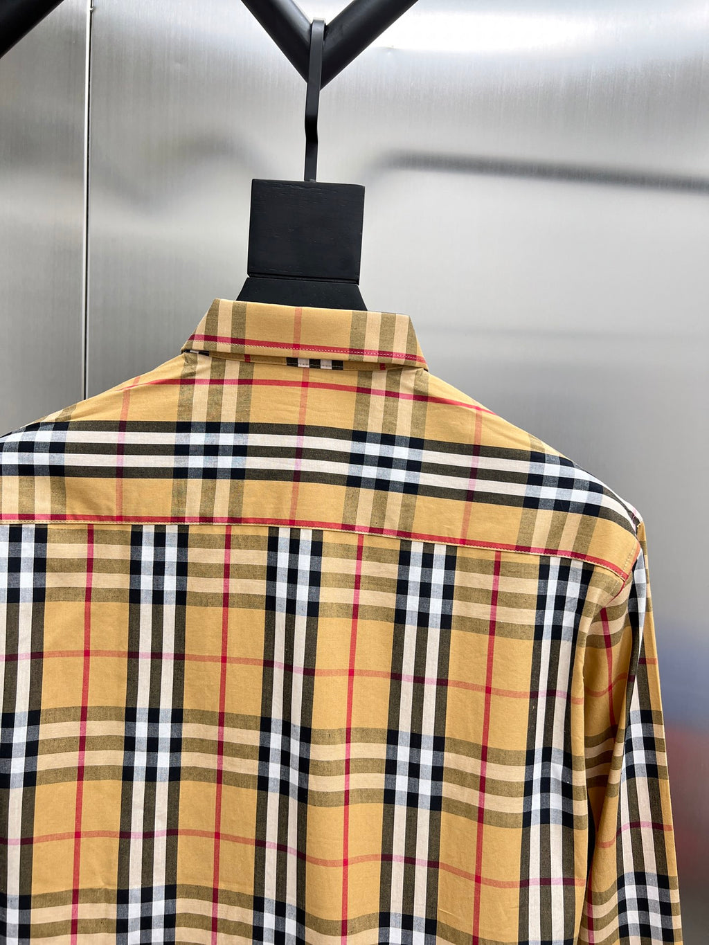 Long-sleeve plaid shirt back with yoke and collar, tan, black, white, and red checks