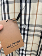Plaid long-sleeve shirt sleeve with Burberry London England hang tag attached.