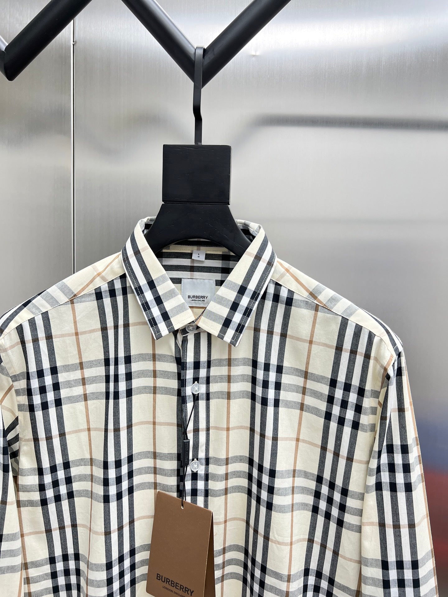 Long-sleeve plaid button-up shirt collar, cream with navy and tan checks.