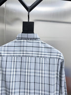 Back view of light blue and navy plaid long-sleeve shirt