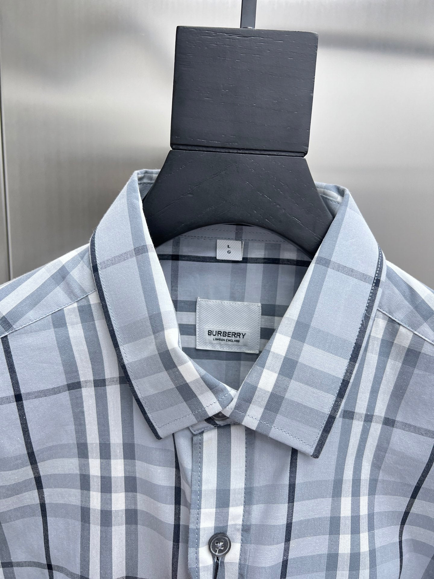 Burberry plaid shirt collar with button placket, light blue and white check close-up