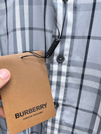 Burberry plaid shirt button placket with hanging tag, light blue and white check