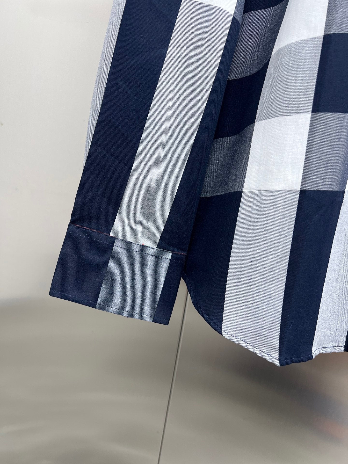 Burberry check shirt sleeve cuff detail with navy and gray/white stripes