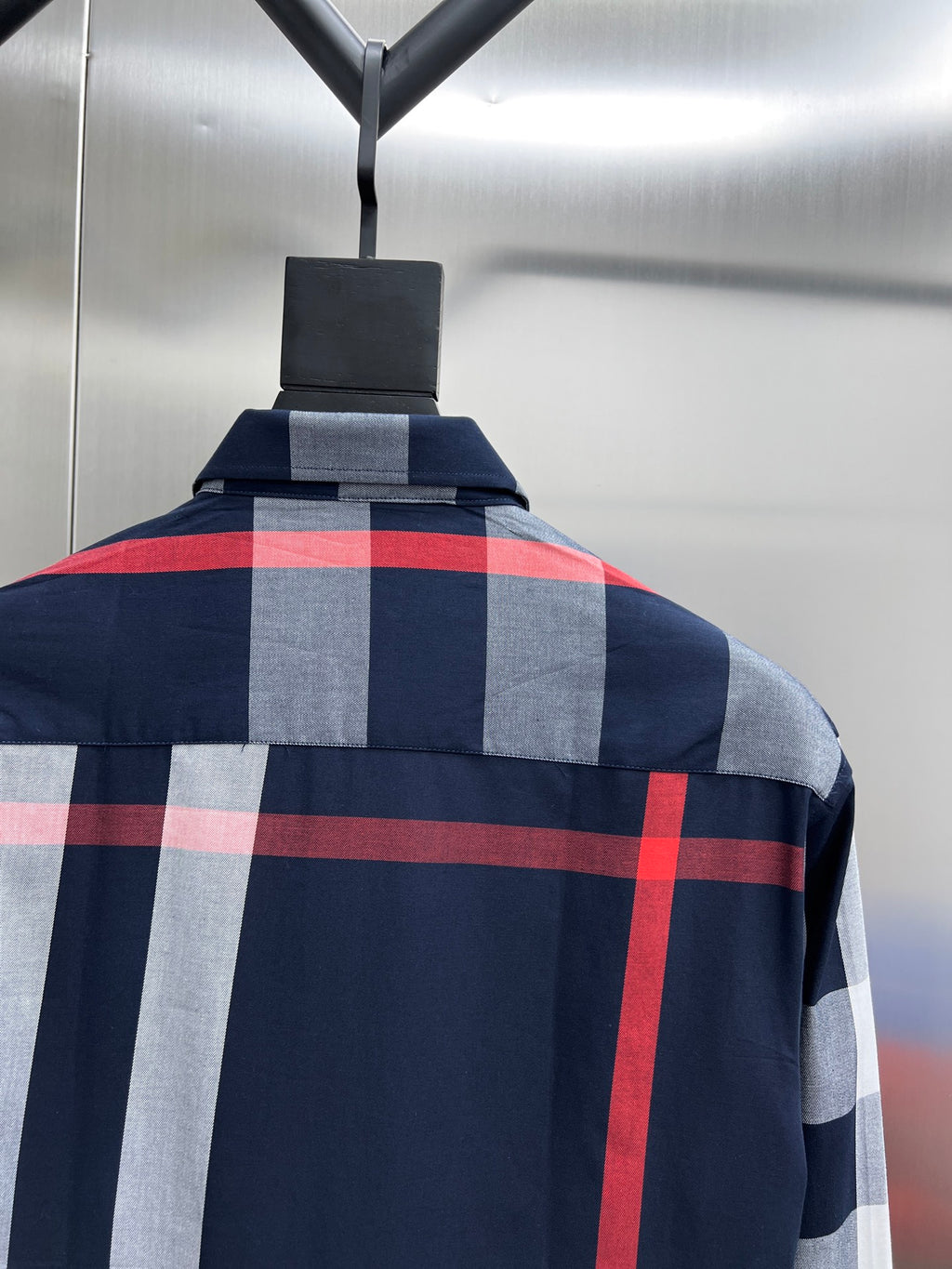 Long-sleeve shirt back with navy, gray, and red check pattern