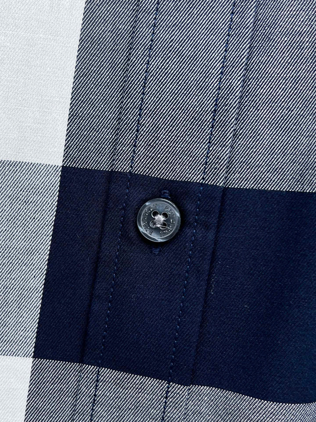 Burberry shirt button on check fabric with navy and gray/white squares