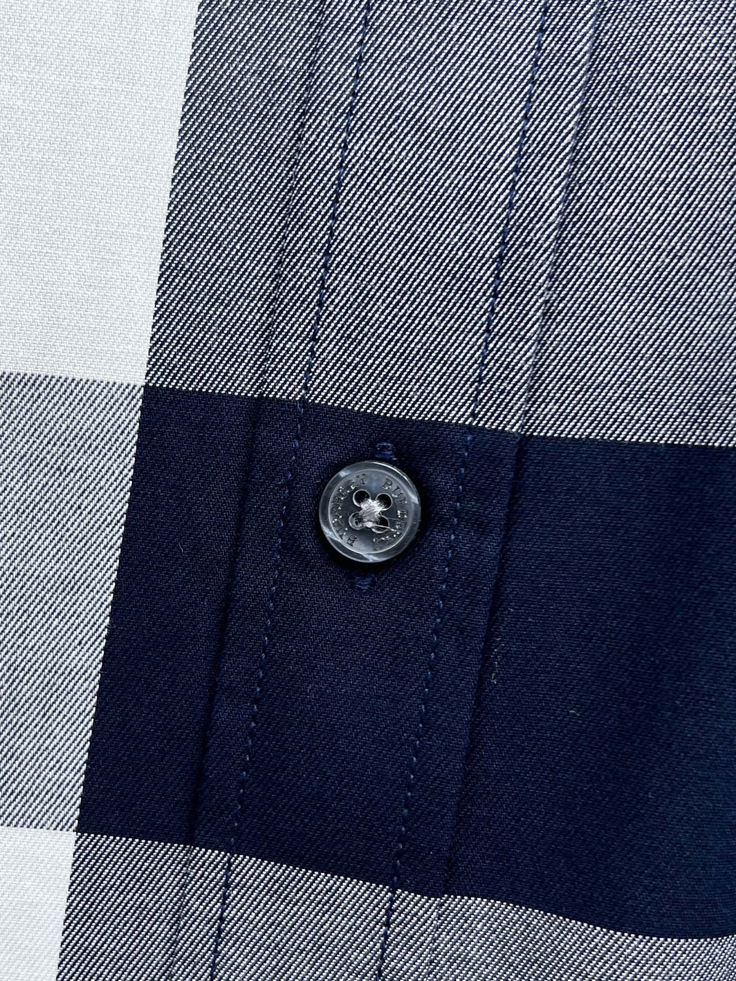 Burberry shirt button on check fabric with navy and gray/white squares