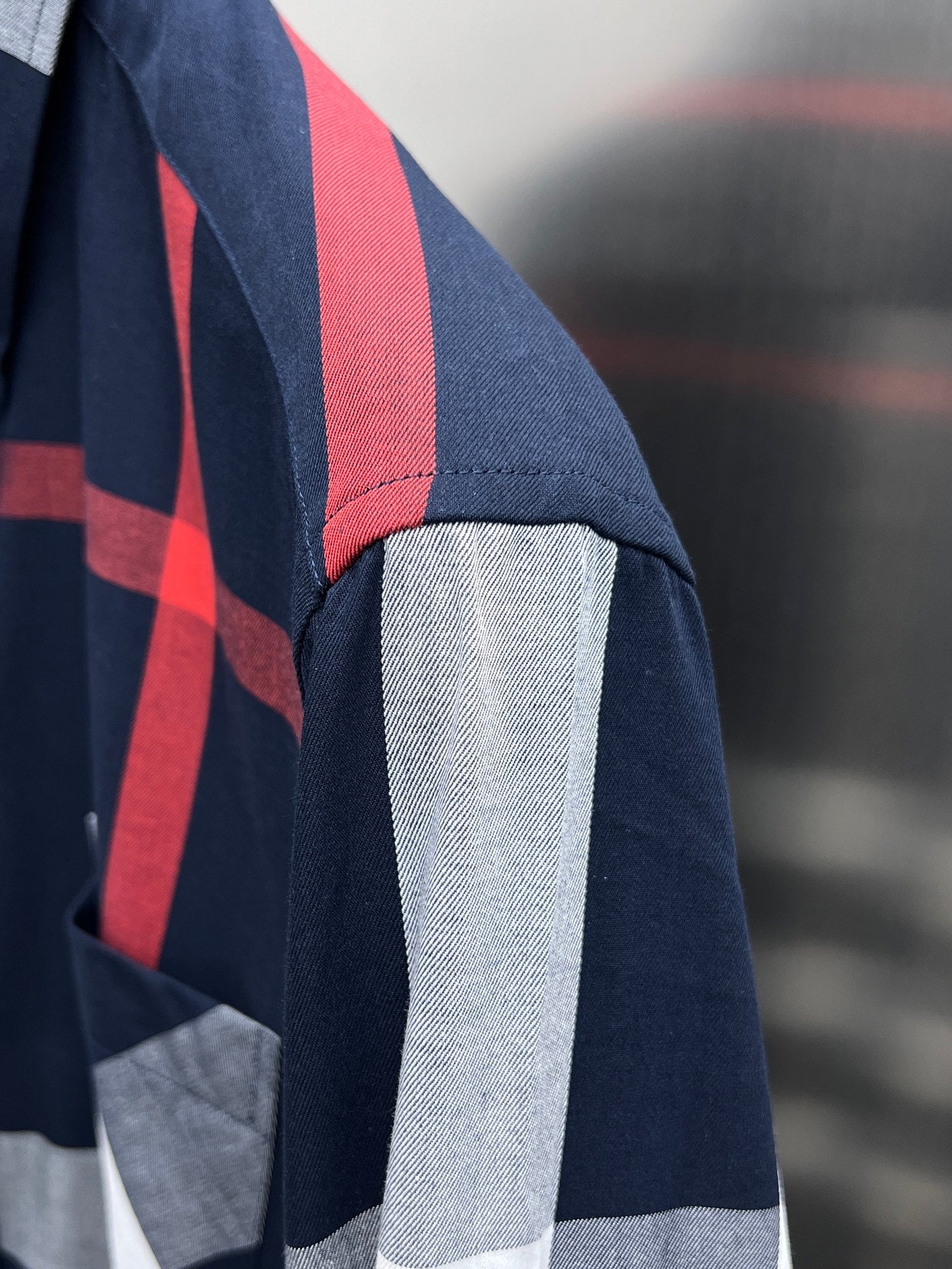 Burberry check shirt sleeve with navy and red vertical stripe and light gray section