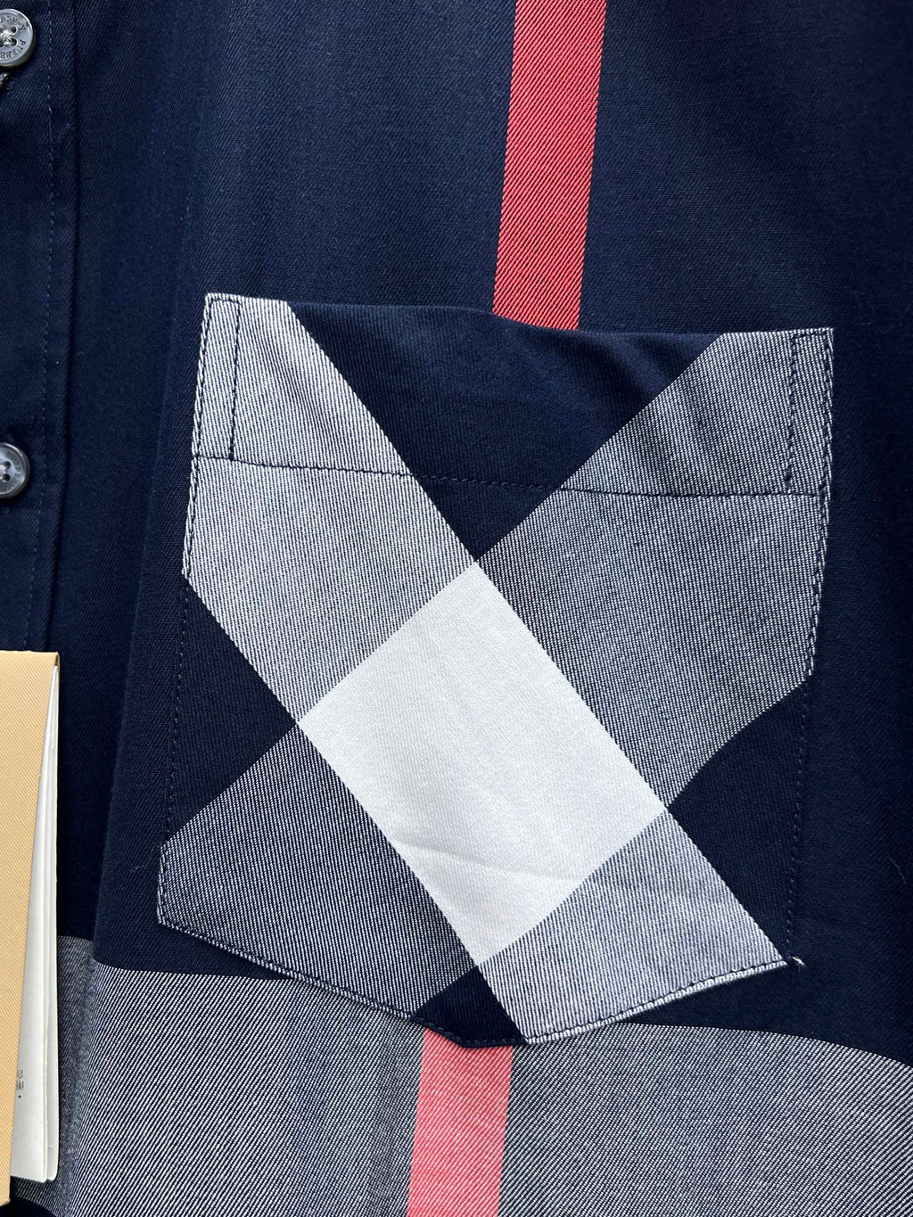 Burberry chest pocket with white and gray diamond check pattern on navy base
