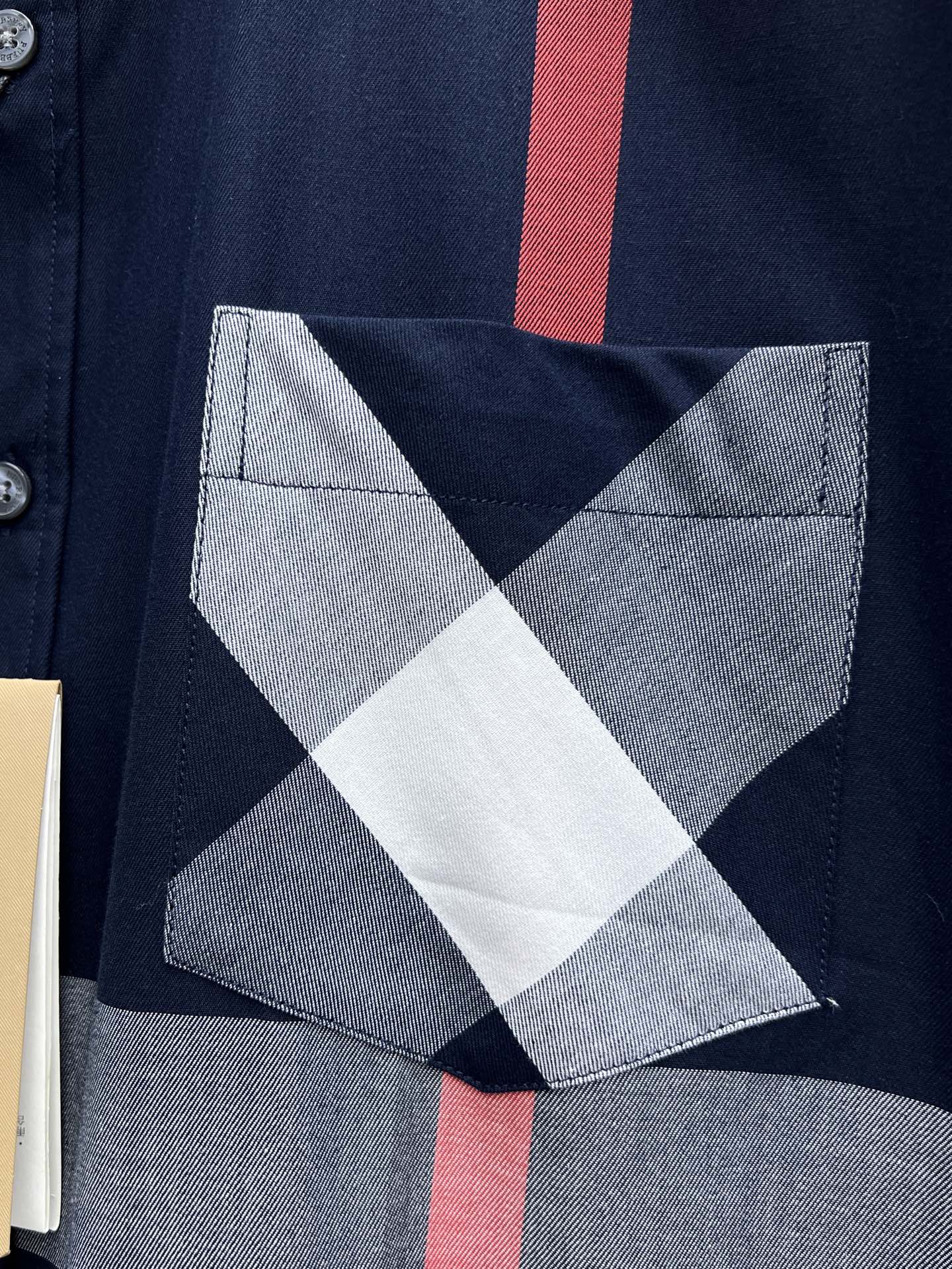 Burberry chest pocket with white and gray diamond check pattern on navy base