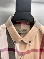 Burberry beige plaid button-up shirt collar with brand hang tag and button placket
