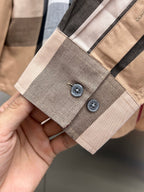 Beige plaid shirt sleeve cuff with two buttons and stitched placket