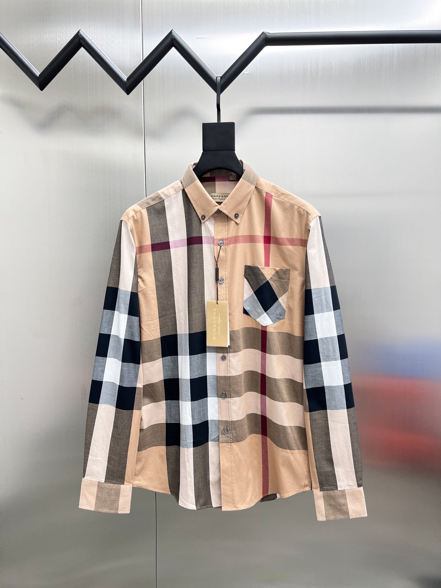 Beige plaid long-sleeve button-up shirt with dark blue checks and chest patch pocket