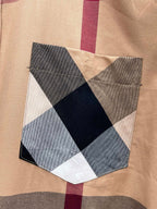 Plaid chest patch with geometric appliqué in navy, gray, and cream