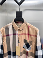 Beige plaid button-up shirt with pointed collar, button front, and chest applique