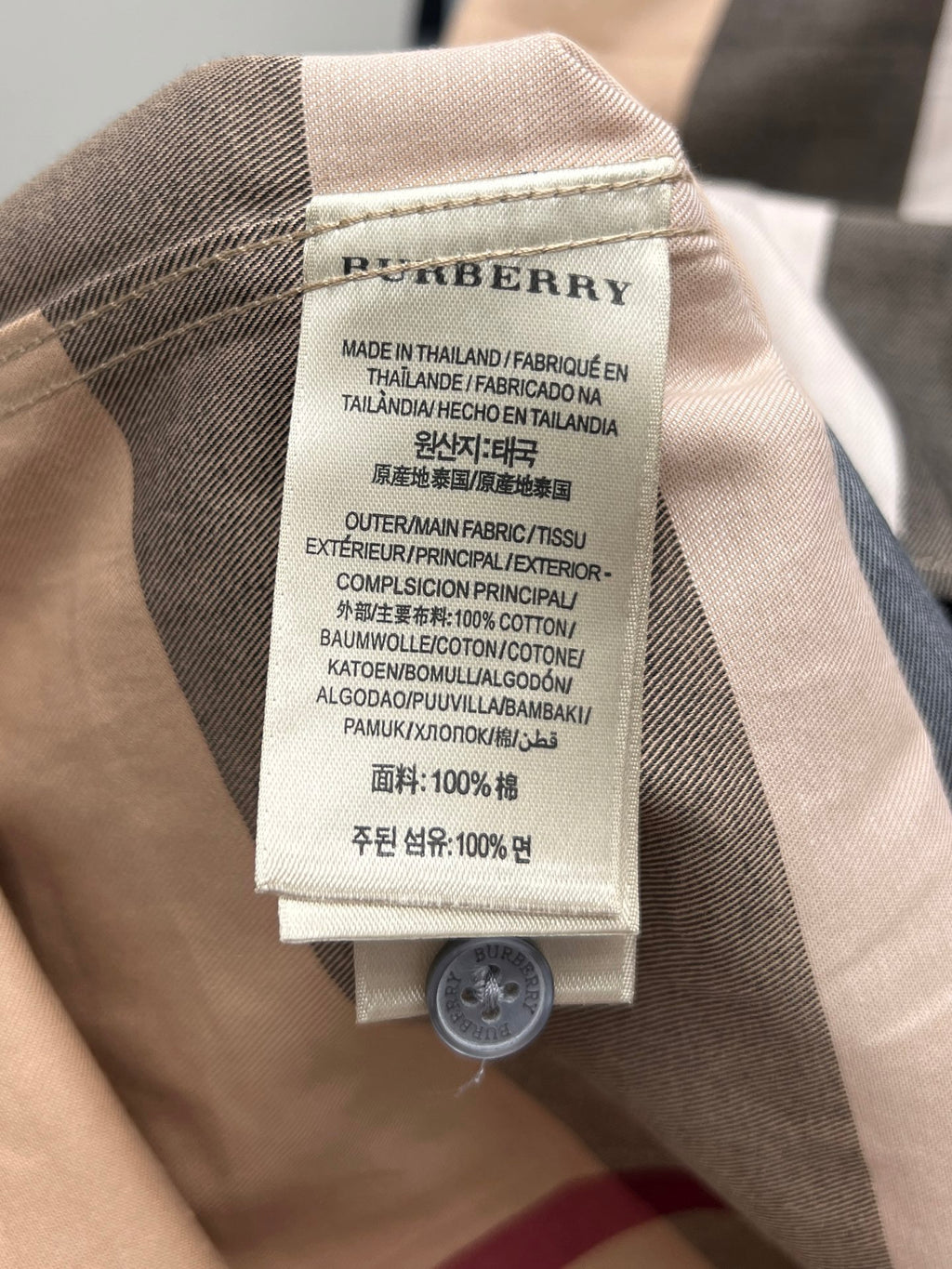 Burberry plaid shirt neck label with fabric content and care instructions