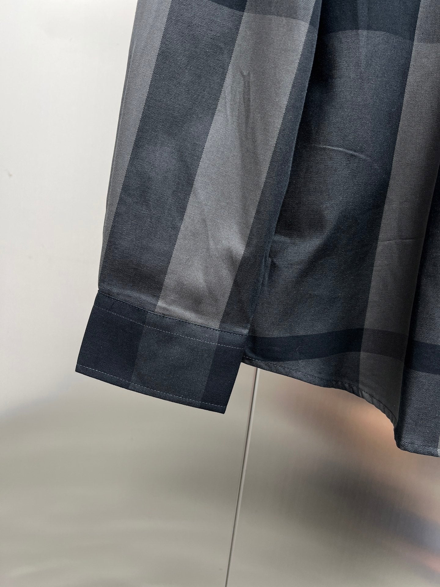 Burberry long-sleeve check shirt cuff and hem, dark blue-gray plaid fabric
