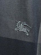 Burberry horse logo embroidery on dark blue-gray plaid shirt fabric