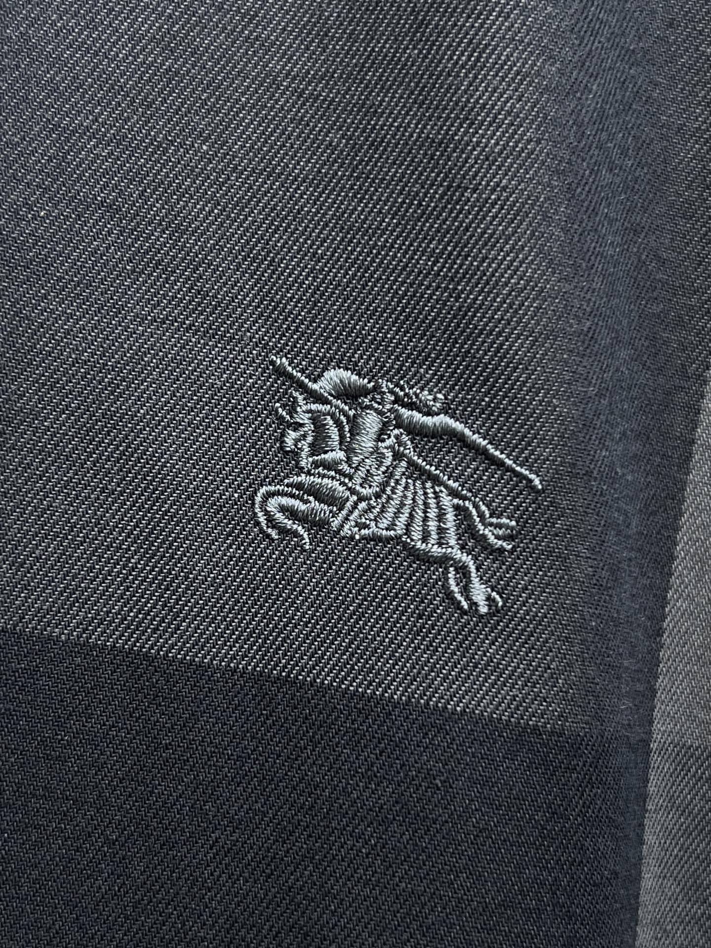 Burberry horse logo embroidery on dark blue-gray plaid shirt fabric