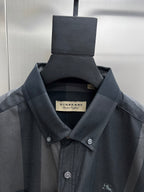 Burberry check long-sleeve shirt close-up, dark blue-gray fabric with small chest logo