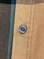 Burberry logo button on beige shirt placket with stitched panel