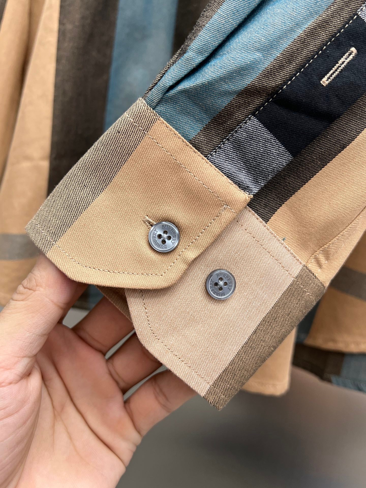 Check-pattern shirt placket and cuff in tan with blue and dark panels, two buttons