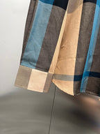 Burberry shirt lower section with plaid hem in beige, blue, and dark tones