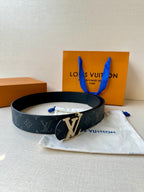 Louis Vuitton monogram belt with dark strap and gold-tone LV buckle emblem