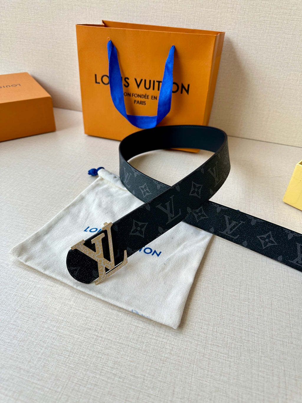Louis Vuitton monogram belt with dark strap and gold-tone LV buckle