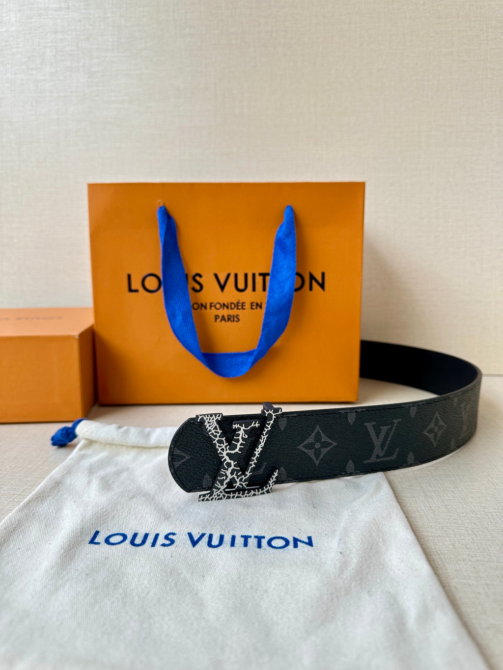 Louis Vuitton monogram belt with dark strap and silver-tone LV buckle