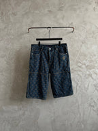 Dark blue denim pants with gold geometric embroidery and button closure