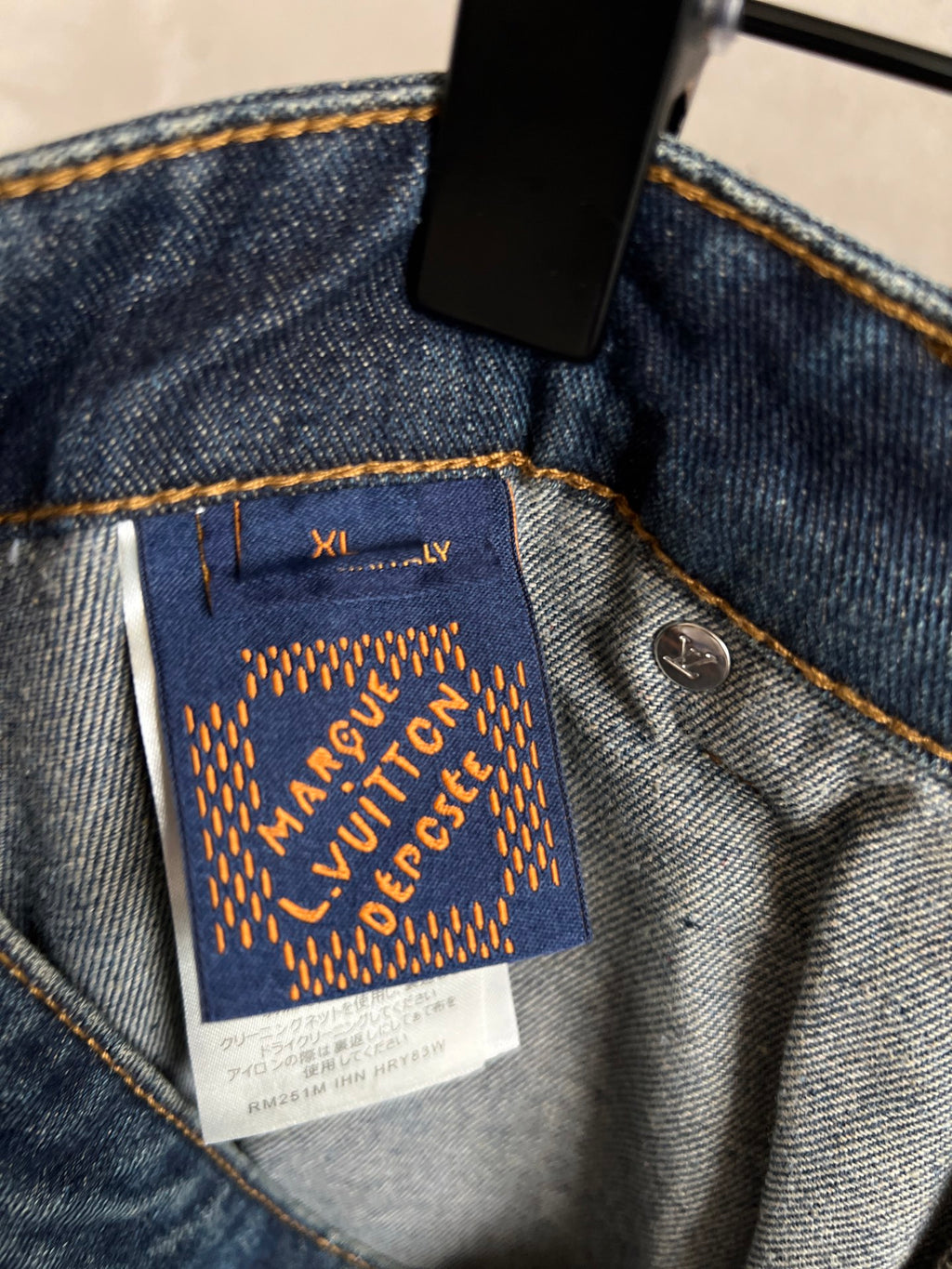 Louis Vuitton Paris fabric label on dark blue denim pocket with gold embroidery