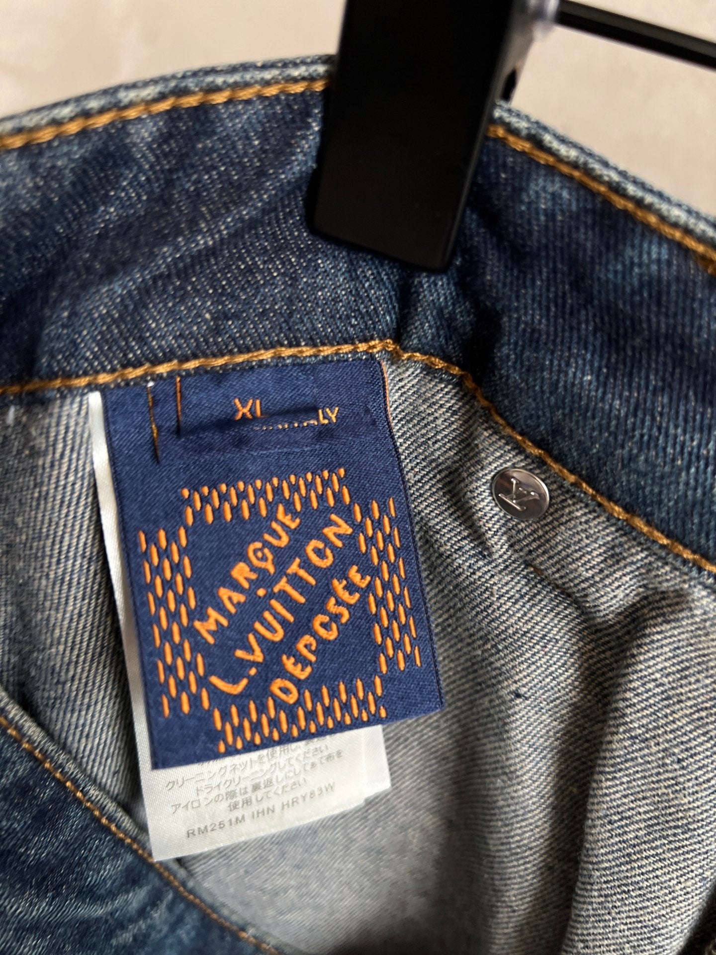 Louis Vuitton Paris fabric label on dark blue denim pocket with gold embroidery