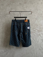 Dark blue denim pants with gold patterned embroidery and hanging size tag