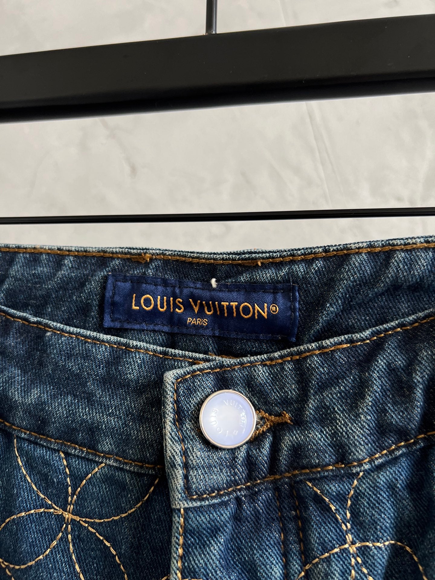 Louis Vuitton Paris logo on dark blue denim waistband with button