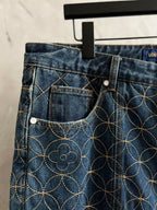 Dark blue denim pants front pockets with gold vine embroidery and button